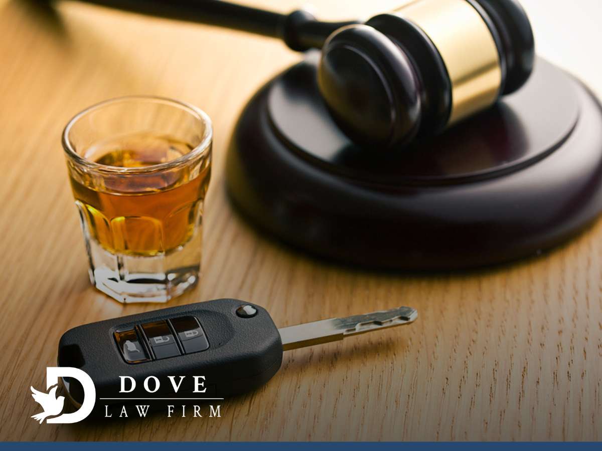 Judge's gavel, a glass of whiskey, and car keys on a table, symbolizing a DUI charge in Arizona.