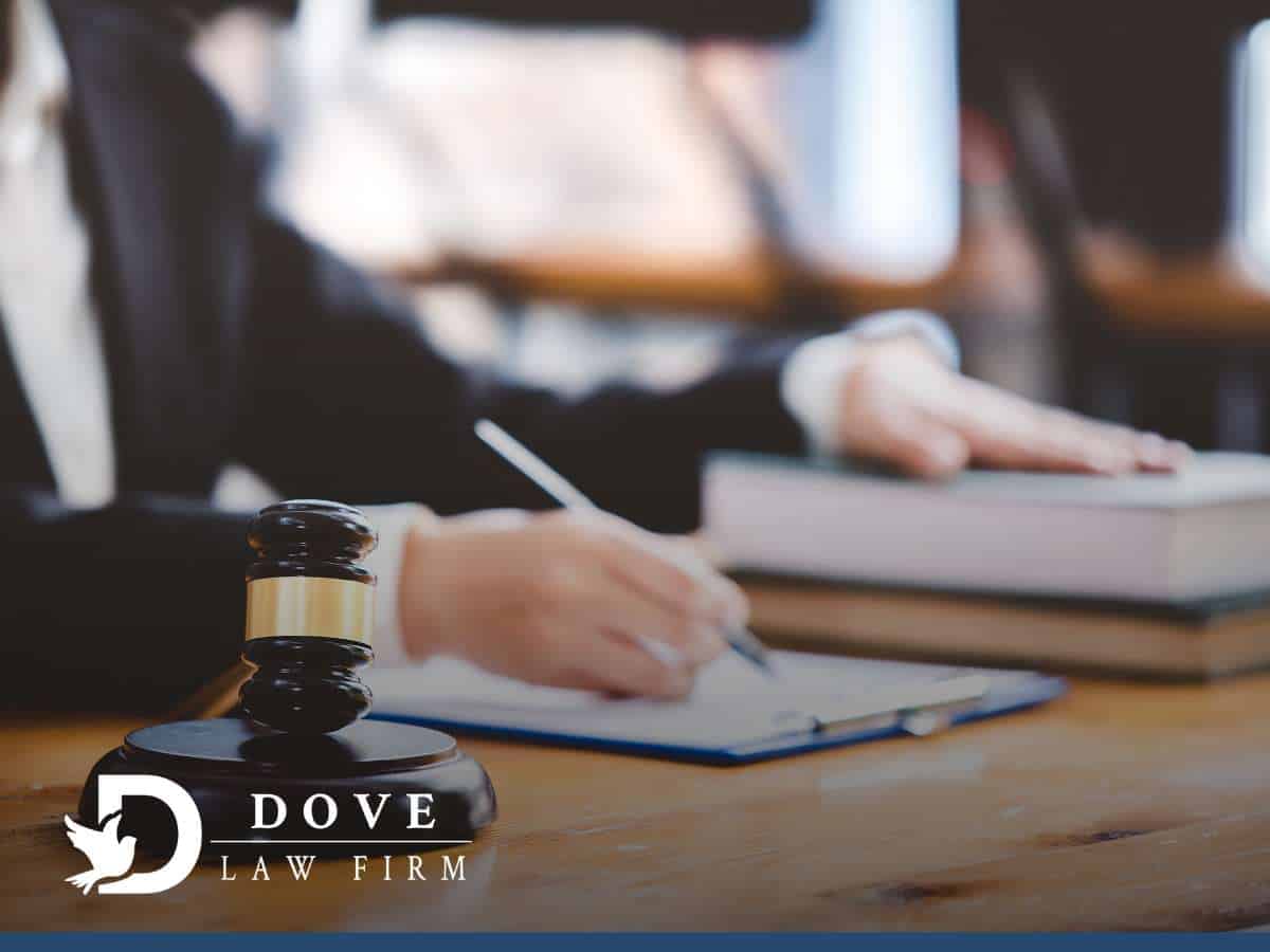 Lawyer reviewing legal documents with a gavel on the table, assisting a client with a Criminal Record case